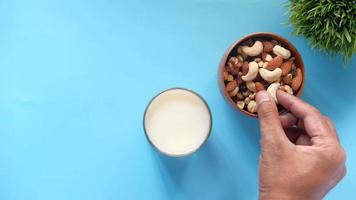 top view of many mixed nuts in a bowl on table and milk video