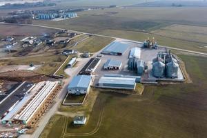 aerial panoramic view on agro-industrial complex with silos and grain drying line for drying cleaning and storage of agricultural products photo