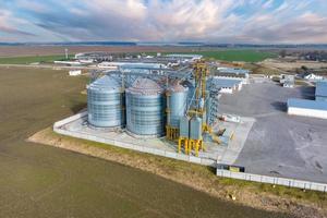 aerial panoramic view on agro-industrial complex with silos and grain drying line for drying cleaning and storage of agricultural products photo