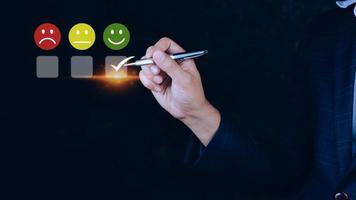 Businessman choosing happy smile face icon. feedback rating and positive customer review experience, satisfaction survey. mental health assessment. World mental health day concept photo