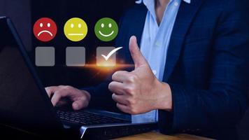 Businessman choosing happy smile face icon. feedback rating and positive customer review experience, satisfaction survey. mental health assessment. World mental health day concept photo