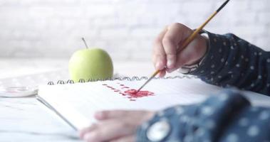 Close up of a child hand drawing with colored pencil on a page video