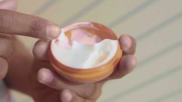 top view of sunscreen cream in a orange container video