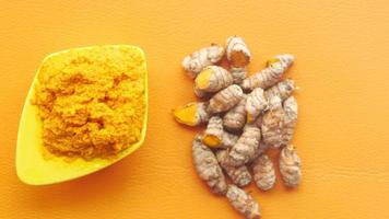 Turmeric root and powder in a bowl video