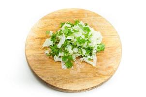 Sliced  lettuce Coriander on wooden board on white background photo