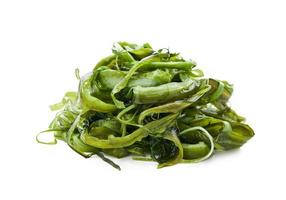 heap of fresh Korean seaweed salad stem side dish or Miyeok Julgi Bokkeum isolated on white background. Laminaria or Kelp Seaweed stem photo