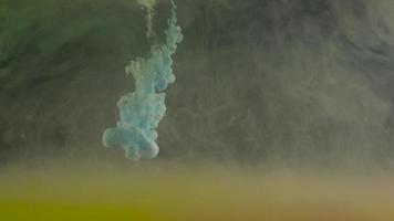 Color drop underwater creating a silk drapery. Ink swirling underwater. Reverse shooting video