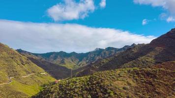 Hyper lapse of clouds running on blue sky over amazing landscape of snowy mountains and coniferous forest on the slopes video