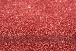 red dust spark glitter texture christmas abstract sparkle background. close up red dust spark glitter texture christmas abstract sparkle background. red bokeh glitter photo