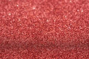 red dust spark glitter texture christmas abstract sparkle background. close up red dust spark glitter texture christmas abstract sparkle background. red bokeh glitter photo