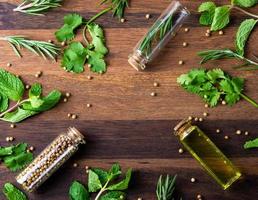 top view fresh spices and herbs with glasses on wooden table photo