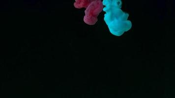 Color drop underwater creating a silk drapery. Ink swirling underwater. Slow motion video