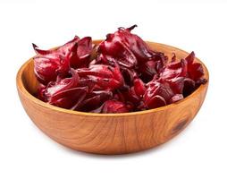fresh red roselle fruits or hibiscus sabdariffa in wooden bowl isolated on white background with clipping path photo