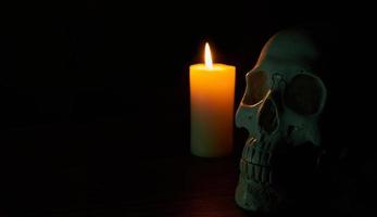 white skull with candles in dark or black on a background photo