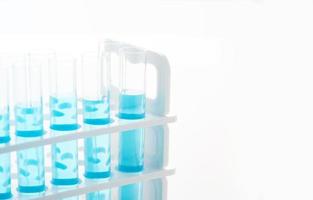 concept of science biology test tube with blue liquid on white background photo