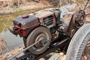 homemade water pump machine in rural farm background photo