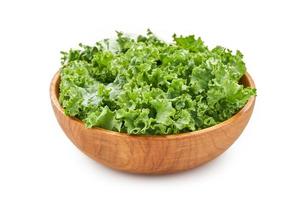 fresh green Kale leaves bunch leaf cabbage in wood plate isolated on white background. green kale or leaf cabbage in a wooden bowl isolated photo