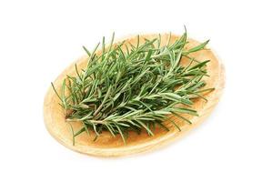 rosemary in wood bowl isolated on white background. spice rosemary isolated on white background. rosemary photo