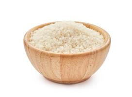 heap of short grain rice in wood bowl isolated on white background. Japonica rice photo