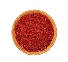 a pile of red pepper flake or heap of red pepper powder coarse. korean chili ground Gochugaru in wood bowl isolated on white background. top view, flat lay, overhead photo