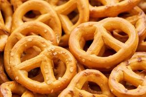 closeup mini salted pretzel in a wooden plate on wood table background. photo