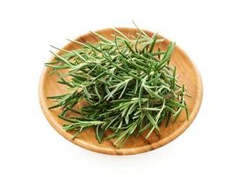 rosemary in wood bowl isolated on white background. spice rosemary isolated on white background. rosemary photo