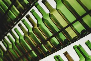 Many translucent empty wine bottles photo