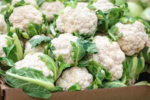 Cauliflower in a cardboard box in the grocery store photo