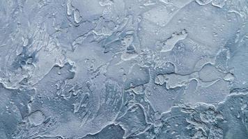 artificial stone wall texture, white gray blue smeared stains of textured cement photo