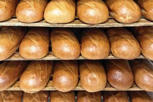 Bread shelves stand in bakery or supermarket photo