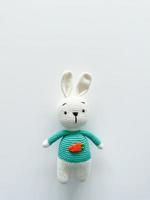 Soft white crochet bunny. on a white background. photo