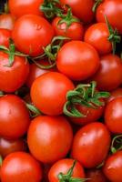 Fresh red cherry tomatoes in a wooden vintage box photo