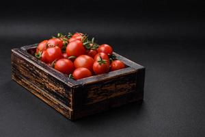 Fresh red cherry tomatoes in a wooden vintage box photo