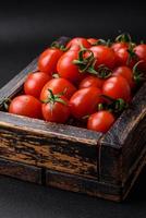 Fresh red cherry tomatoes in a wooden vintage box photo