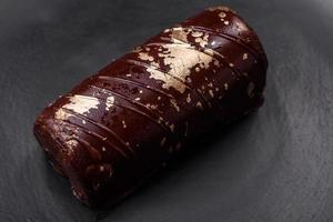 Delicious sweet cheese with syrup covered with chocolate and nuts photo