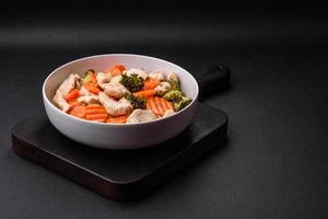 Delicious dish consisting of pieces of boiled chicken, broccoli and carrots photo