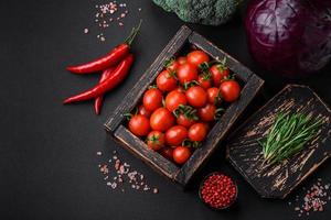 Fresh red cherry tomatoes in a wooden vintage box photo