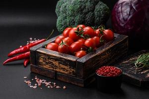 Fresh red cherry tomatoes in a wooden vintage box photo