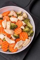 Delicious dish consisting of pieces of boiled chicken, broccoli and carrots photo