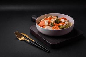 Delicious dish consisting of pieces of boiled chicken, broccoli and carrots photo