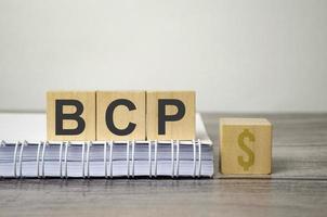 bcp text from wooden blocks on a grey wooden background photo