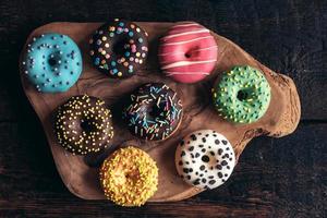 Mini American donuts on wooden board photo