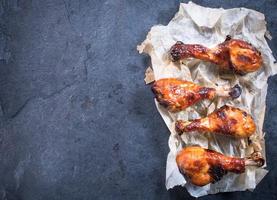 Chicken drumsticks in paper photo