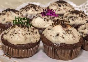 Homemade freshly baked cupcakes or muffins with happy birthday photo