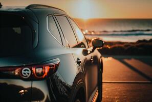 Electric suv cars parked in the coastal road with the sea in the background. photo