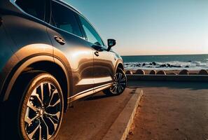 Electric suv cars parked in the coastal road with the sea in the background. photo