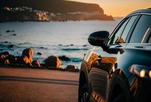 Electric suv cars parked in the coastal road with the sea in the background. photo