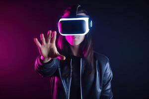 a woman wearing a virtual reality headset touching the virtual object on dark background. photo