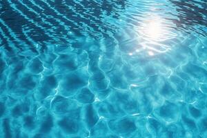 Pool water surface background with sunlight reflection. photo