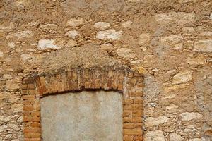 Wall with a window above picturesque background photo